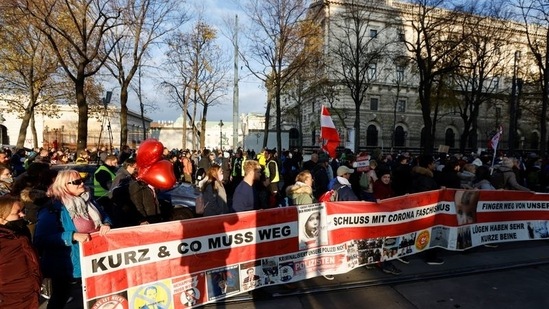 Demonstrators hold flags and placards as they gather to protest against the coronavirus disease (COVID-19) measures in Vienna, Austria(Reuters) Demonstrators hold flags and placards as they gather to protest against the coronavirus disease (COVID-19) measures in Vienna, Austria(Reuters)