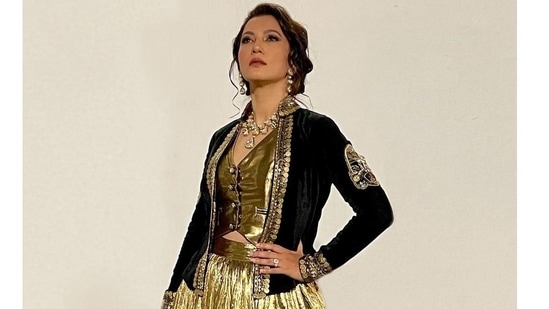 The pictures featured the actor donning a lehenga made of crush gold silk jacquard and teamed with a plain gold cut sleeves waist-coat/corset that came with a dori back detailing.(Instagram/gauaharkhan)