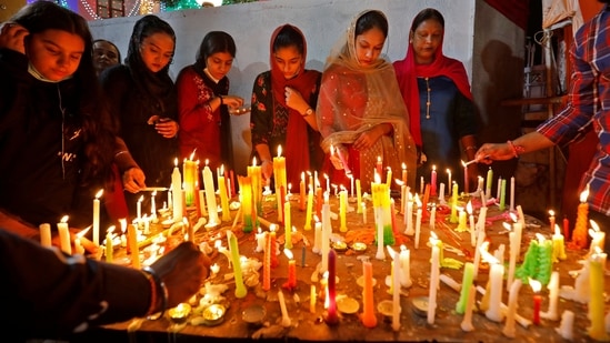 Women devotees in traditional attires light candles at Gurudwara Gobind Dham, Ahmedabad to pay tribute to Sikhism founder Guru Nanak Dev Ji on his birth anniversary.(REUTERS)