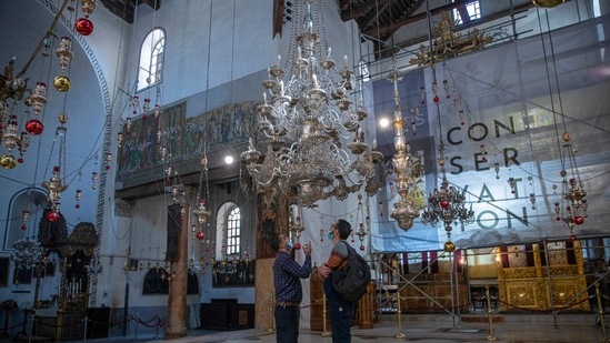 Tourists visit the Church of the Nativity, in the West Bank city of Bethlehem. While the region is finally welcoming foreign tourists after a year-and-a-half-long Covid-19 shutdown, few travellers are making their way to the birthplace of Jesus this holiday season&nbsp;(AP Photo/Nasser Nasser)