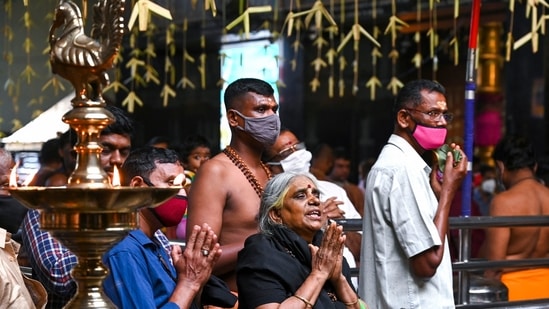 Devotees offer prayers during a ritual to worship Lord Ayyappa.(AFP Photo)