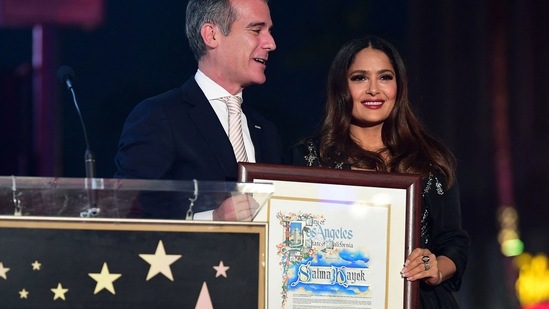 Salma Hayek (R) receives a plaque from Los Angeles Mayor Eric Garcetti.(AFP)