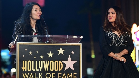 Chinese filmmaker Chloe Zhao (L) speaks during the ceremony. Chloe directed Eternals, which starred Salma.(AFP)