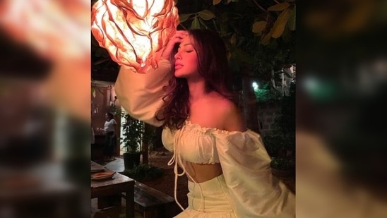 Mouni Roy never shies away from the camera and always manages to strike some stunning poses for her fans. Earlier, the actor stunned in a fancy white off shoulder full puff sleeves crop top and skirt set.(Instagram/@imouniroy)