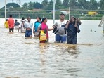 Residents wade through a flood-affected area in Nellore district of Andhra Pradesh(PTI Photo) Residents wade through a flood-affected area in Nellore district of Andhra Pradesh(PTI Photo)