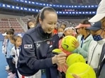 Chinese tennis player Peng Shuai signs large-sized tennis balls at the opening ceremony of Fila Kids Junior Tennis Challenger Final in Beijing, China November 21, 2021, in this screen grab obtained from a social media video.&nbsp;