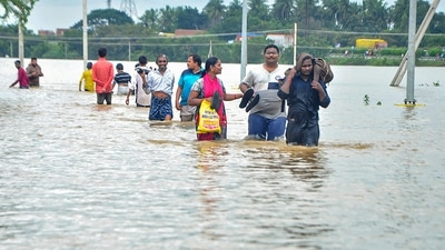 Residents wade through a flood-affected area in Nellore district of Andhra Pradesh (PTI Photo) Residents wade through a flood-affected area in Nellore district of Andhra Pradesh (PTI Photo)