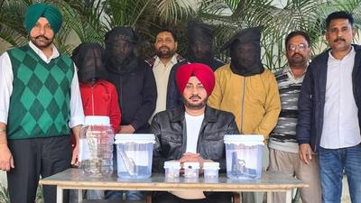 The men accused of executing a jewellery shop robbery in Ludhiana police custody on Sunday. (HT Photo) The men accused of executing a jewellery shop robbery in Ludhiana police custody on Sunday. (HT Photo)