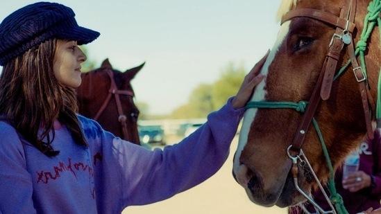 Ananya Panday pets a horse.&nbsp;