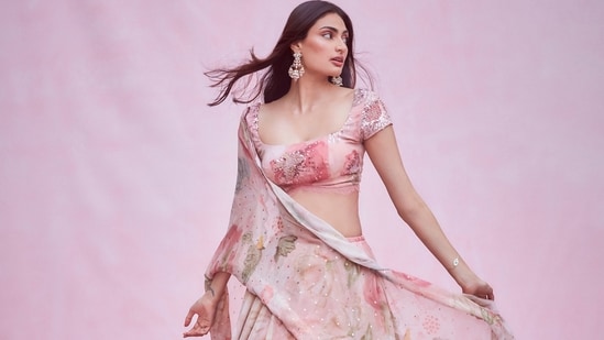 For one of the traditional ceremonies, Athiya dolled up in a pink floral lehenga from Indian designer Shehla Khan's eponymous label that stunned the fashion police and even we could not keep calm.(Amigos Communications)