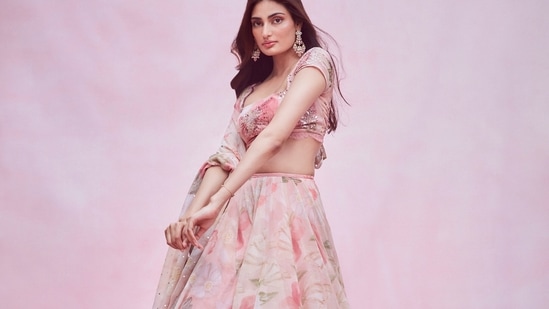 She teamed it with an organza lehenga and layered it with an organza dupatta, both of which came with baby pink base and sported bright pink and green floral prints and sequins embroidery all over.(Amigos Communications)