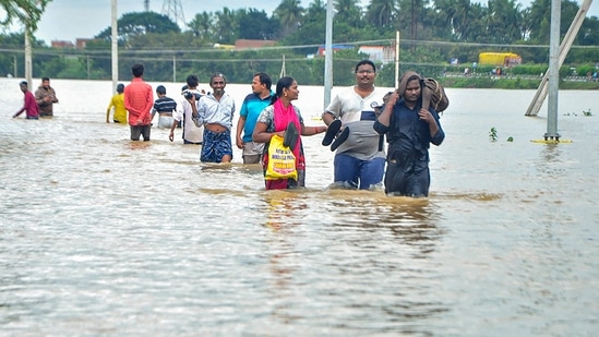 Residents wade through a flood-affected area in Nellore district of Andhra Pradesh(PTI Photo)
