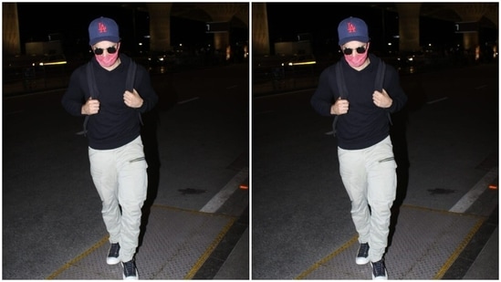 Varun Dhawan paired a black tee shirt and a pair of white trousers for a comfortable flight.(HT Photos/Varinder Chawla)