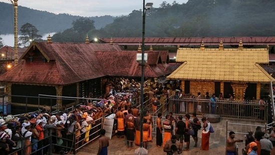 Devotees wait in queues inside the premises of the Sabarimala temple in Pathanamthitta district of Kerala in this file photo.(Reuters)