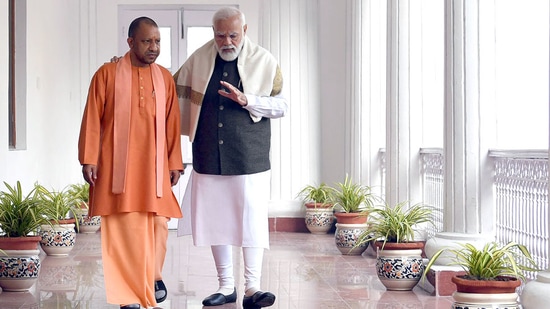 Uttar Pradesh chief minister Yogi Adityanath meets Prime Minister Narendra Modi at Raj Bhavan in Lucknow.(Twitter/@myogiadityanath)