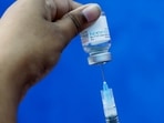 A healthcare worker fills a syringe with a dose of Covaxin at a municipal health centre in Kolkata.