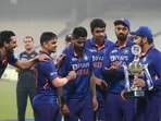 India's captain Rohit Sharma walks with the winners trophy after their win in the third Twenty20 cricket match against New Zealand in Kolkata.(AP)