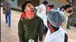 Mumbai, India -Nov 21, 2021: A BMC health worker collects swab samples for Covid-19 test of passengers arriving on outstation trains at Dadar Station, on 20 November 2021, in Mumbai, India, on Sunday, Nov 21, 2021. (Photo by Bhushan Koyande/ HT Photo) (HT PHoto) Mumbai, India -Nov 21, 2021: A BMC health worker collects swab samples for Covid-19 test of passengers arriving on outstation trains at Dadar Station, on 20 November 2021, in Mumbai, India, on Sunday, Nov 21, 2021. (Photo by Bhushan Koyande/ HT Photo) (HT PHoto)