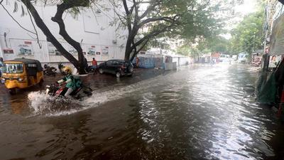 A vehicle wades through a waterlogged street after heavy rains in Chennai on Monday. (Agencies) A vehicle wades through a waterlogged street after heavy rains in Chennai on Monday. (Agencies)