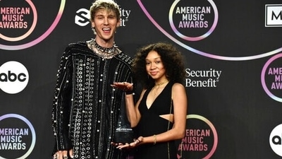 Machine Gun Kelly and his daughter Casie Colson Baker twin in black as they arrive at the American Music Awards 2021. Machine Gun Kelly took home the award for favourite rock artist. (Invision) Machine Gun Kelly and his daughter Casie Colson Baker twin in black as they arrive at the American Music Awards 2021. Machine Gun Kelly took home the award for favourite rock artist. (Invision)