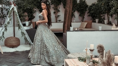 She teamed it with a moss green lehenga that was embroidered in geometric floral artwork with multiple borders and set with gold and silver sequins along with beads and zari work. (Instagram/alannapanday) She teamed it with a moss green lehenga that was embroidered in geometric floral artwork with multiple borders and set with gold and silver sequins along with beads and zari work. (Instagram/alannapanday)