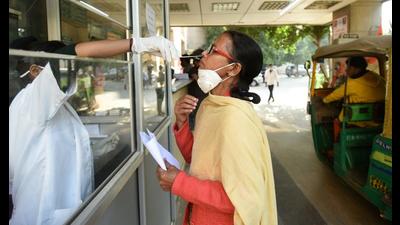 A health worker collects a sample for Covid-19 test at the district hospital in Noida’s Sector 30 on Monday. (Sunil Ghosh/HT) A health worker collects a sample for Covid-19 test at the district hospital in Noida’s Sector 30 on Monday. (Sunil Ghosh/HT)
