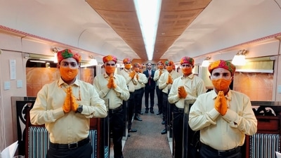 Serving staff on board the Ramayan Express, Monday, Nov. 22, 2021. Railways on Monday changed the uniforms of its serving staff on board the Ramayan Express after seers from Ujjain objected to the saffron attire of waiters on board the train. (PTI Photo) Serving staff on board the Ramayan Express, Monday, Nov. 22, 2021. Railways on Monday changed the uniforms of its serving staff on board the Ramayan Express after seers from Ujjain objected to the saffron attire of waiters on board the train. (PTI Photo)