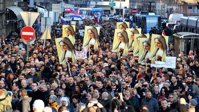 Demonstrators march in the center of Zagreb, Croatia, to protest against Covid-19 measures such as obligatory certificates for public sector. (AFP)