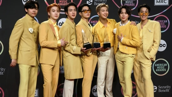 BTS' Jin, Suga, V, Jungkook, RM, Jimin, and J-Hope hold their trophies for the Favourite Pop Song, Favourite Duo or Group and Artist of the Year awards at the 2021 American Music Awards in Los Angeles. (REUTERS)