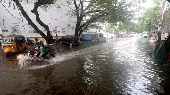 A vehicle wades through a waterlogged street after heavy rains in Chennai on Monday. (Agencies)