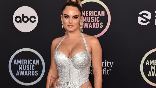 JoJo flaunted her curves as she posed in a dazzling silver body-hugging halter gown at the American Music Awards.(Invision)