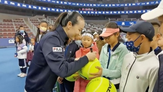 Chinese tennis player Peng Shuai signs large-sized tennis balls at the opening ceremony of Fila Kids Junior Tennis Challenger Final in Beijing, China.(via REUTERS)