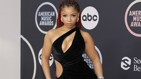 Chlöe attended the 2021 American Music Awards at Microsoft Theater donning a long thigh-high slit velvet black dress.(AFP)
