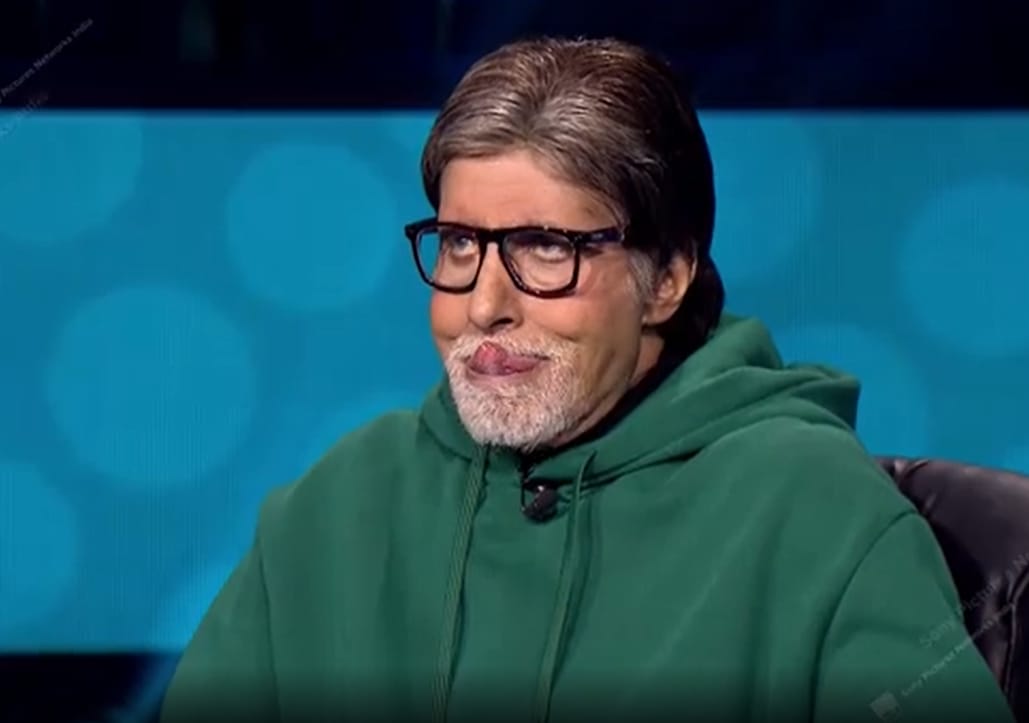 Amitabh Bachchan with a contestant on KBC 13. Amitabh Bachchan with a contestant on KBC 13. 