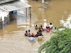 Residents wade through a flood-affected area in Nellore district of Andhra Pradesh on Sunday.(PTI Photo) Residents wade through a flood-affected area in Nellore district of Andhra Pradesh on Sunday.(PTI Photo)