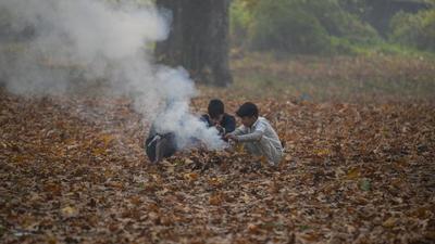 Boys warm their hands over the burning China leaves on the outskirts of Srinagar. (AP Photo) Boys warm their hands over the burning China leaves on the outskirts of Srinagar. (AP Photo)