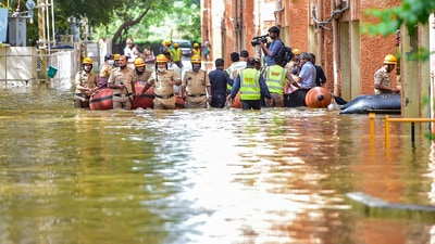 National Disaster Response Force (NDRF) personnel evacuate the residents of Kendriya Vihar from a flooded area in Bengaluru. (PTI)