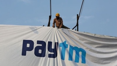 A worker adjusts a hoarding of Paytm in Ahmedabad. (Reuters File Photo)