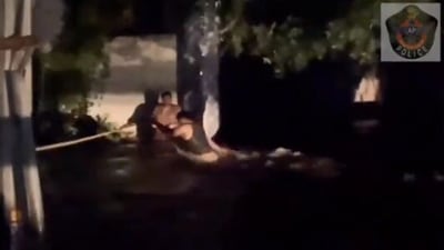 The image shows the policeman rescuing the priest. (Twitter/@APPOLICE100)