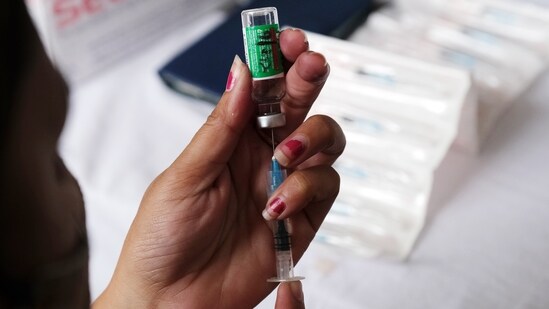 A health worker prepares a dose of the Covishield vaccine, developed by Oxford-AstraZeneca Plc. and manufactured by Serum Institute of India Ltd.(Bloomberg)