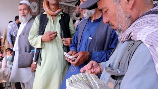 Afghanistan's total credits fell to USD 307 million in September from USD 33 billion at the end of last year. In picture - Afghan money exchange dealers wait for customers at a money exchange market.(Reuters)