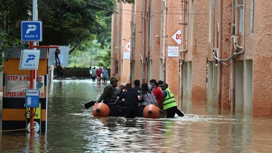 Rescue workers move stranded residents of an apartment in a boat after it was flooded due to heavy rains in Bengaluru.(AP)