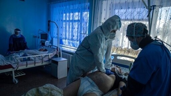 Medical staff treat a coronavirus patient at a tent hospital erected for COVID-19 patients in Kakhovka, Ukraine(AP Photo) Medical staff treat a coronavirus patient at a tent hospital erected for COVID-19 patients in Kakhovka, Ukraine(AP Photo)
