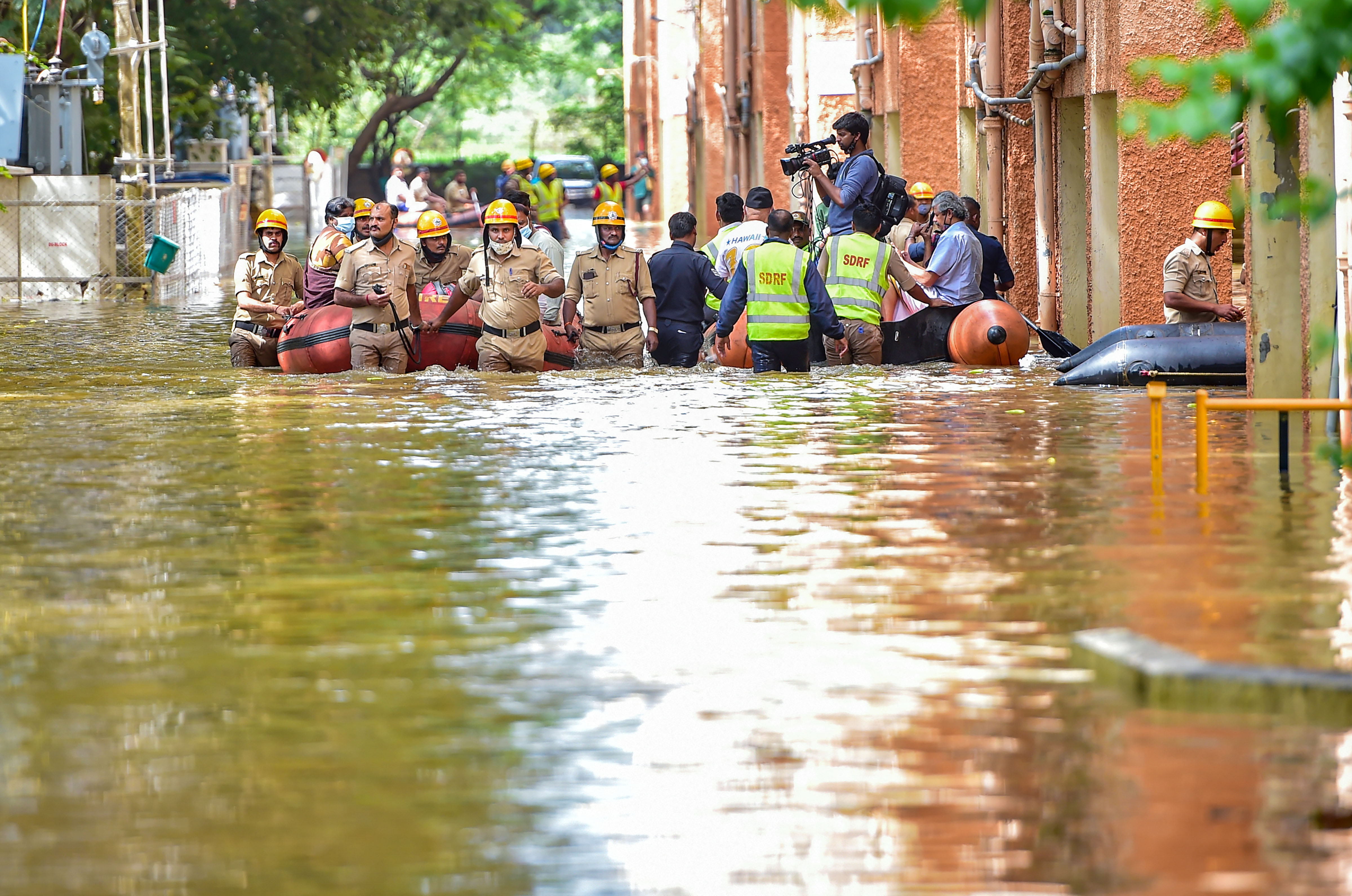 National Disaster Response Force (NDRF) personnel evacuate the residents of Kendriya Vihar from a flooded area in Bengaluru. (PTI) National Disaster Response Force (NDRF) personnel evacuate the residents of Kendriya Vihar from a flooded area in Bengaluru. (PTI)