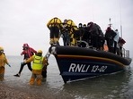 Migrants are helped ashore from a lifeboat at a beach in Dungeness, on the south-east coast of England.(AFP) Migrants are helped ashore from a lifeboat at a beach in Dungeness, on the south-east coast of England.(AFP)