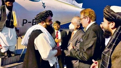 Afghanistan’s acting foreign minister Amir Khan Muttaqi greets Abdul Razak Dawood, advisor to Pakistan PM Imran Khan up on his arrival in Islamabad on November 10. (REUTERS) Afghanistan’s acting foreign minister Amir Khan Muttaqi greets Abdul Razak Dawood, advisor to Pakistan PM Imran Khan up on his arrival in Islamabad on November 10. (REUTERS)