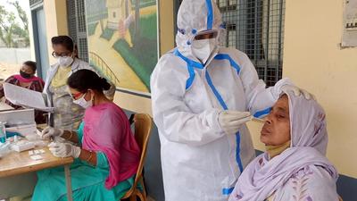 A health worker collect swab samples during Covid testing in Bathinda district in Punjab. (HT file)