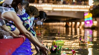 People in Bangkok, Thailand, gather to place krathongs (floating baskets) into a canal during the Loy Krathong festival, which is held as a symbolic apology to the goddess of the river. (REUTERS)