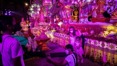 Visitors take photos at Tha Phae Gate during the Loy Krathong festival in Chiang Mai, Thailand. (Bloomberg)