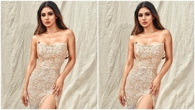 Mouni's strapless dress comes with a plunging neckline, flaunting her collarbones, and golden and blue ombre shaded sequins placed all over the outfit. The risqué side thigh-high slit flaunted her legs and added a sexy charm to Mouni's look. (Instagram/@imouniroy) Mouni's strapless dress comes with a plunging neckline, flaunting her collarbones, and golden and blue ombre shaded sequins placed all over the outfit. The risqué side thigh-high slit flaunted her legs and added a sexy charm to Mouni's look. (Instagram/@imouniroy)